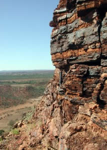 Outcrop at Tchintaby Ridge south of Paraburdoo, Western Australia, with Bangemall Basin dolomitic sandstones overlying massive turbiditic units of the Ashburton Formation. Analysing the age of detrital zircon in these sedimentary rocks provides information about the provenance of the sediment and the tectonic evolution of the region.