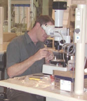 Anthony Budd using stereo binocular microscope