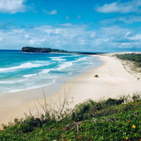 Indian Head, one of the volcanic rock protrusions on the island which is otherwise dominated by sand. &copy; webshots.
