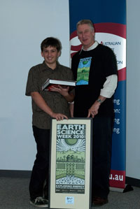 Fig 1.  Morgan Mikulic of Marist College, ACT, receives the Junior Gold Geologi from Dr Chris Pigram, CEO of Geoscience Australia.   
