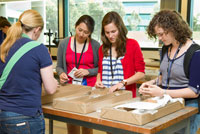 Fig 1.  Students checking the properties of core samples, assisted by Anna Paull of Geoscience Australia, during the National Youth Science Forum workshop in January 2012.
