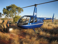 A geophysicist gathering gravity data in a remote desert region. Image courtesy of Daishsat Pty Ltd.