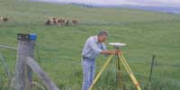 Geoscience Australia staff working in the field using GPS equipment