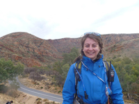 Photograph of Geoscience Australia graduate Millie Crowe taken in 2011 while standing in front of Ormiston Gorge, in West MacDonnell National Park in the Northern Territory during a university field mapping course