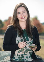 Geoscience Australia graduate Sarlae McAlpine with her hand lens and favourite peridotite rock sample taken during her PhD project
