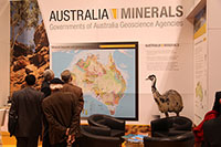 A group of people looking at the mineral deposits and geology of Australia map at the Australia Minerals Booth at PDAC 2013