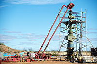This photo shows Petratherm's Paralana 2 well head rigged for a hydraulic fracturing activity undertaken during July 2011, in South Australia. Water was injected at pressures up to 9000 psi and with sustained pump rates of up to 1600 litres per minute. This created a zone of subsurface micro-fracturing extending up to 900 meters in one direction away from the well at a depth of between 3500 and 4000 meters. The largest seismic event detected was magnitude 2.6 on the Richter scale with 98% of the micro-seismic events detected being below 1.0. None of the events were felt outside of the project area, and the project operated well within all of the regulated safety regimes.