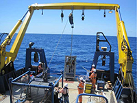 Offloading equipment off the back of a marine research vessel.