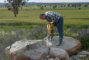 Using a rock drill to sample the Middledale Gabbroic Diorite for SHRIMP zircon analysis, northeast of Temora, New South Wales.