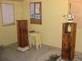 Fig 3. Inside the absolute hut with an Askania declinometer on the primary absolute pier.