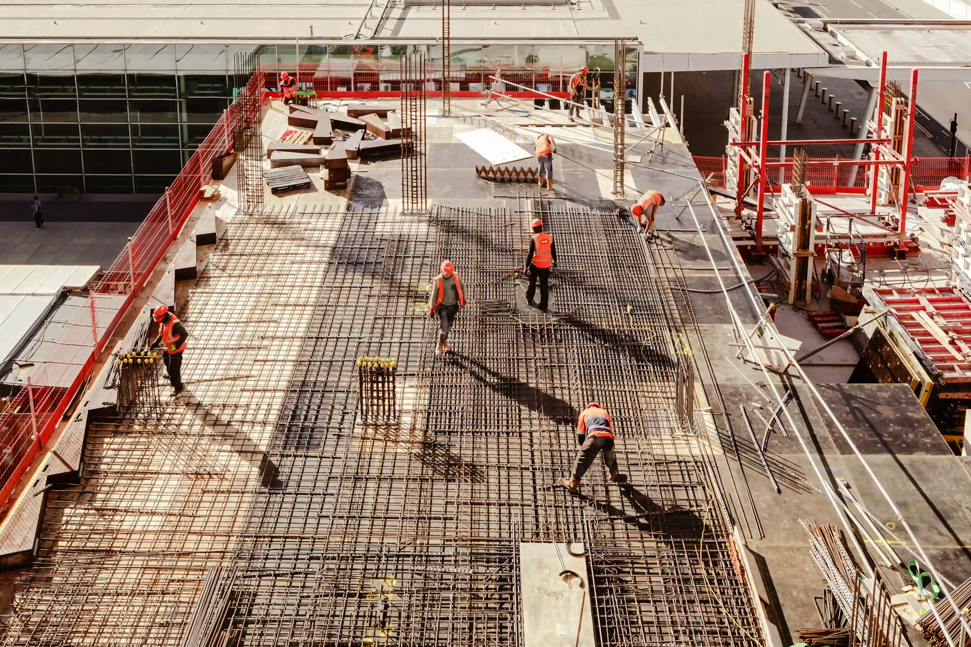 Construction workers at a construction site viewed from above, High angle view of five people with helmets.