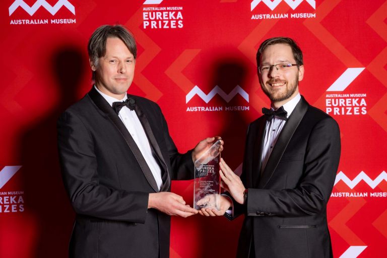 Dr Stuart Walsh and Dr Marcus Haynes holding up an award