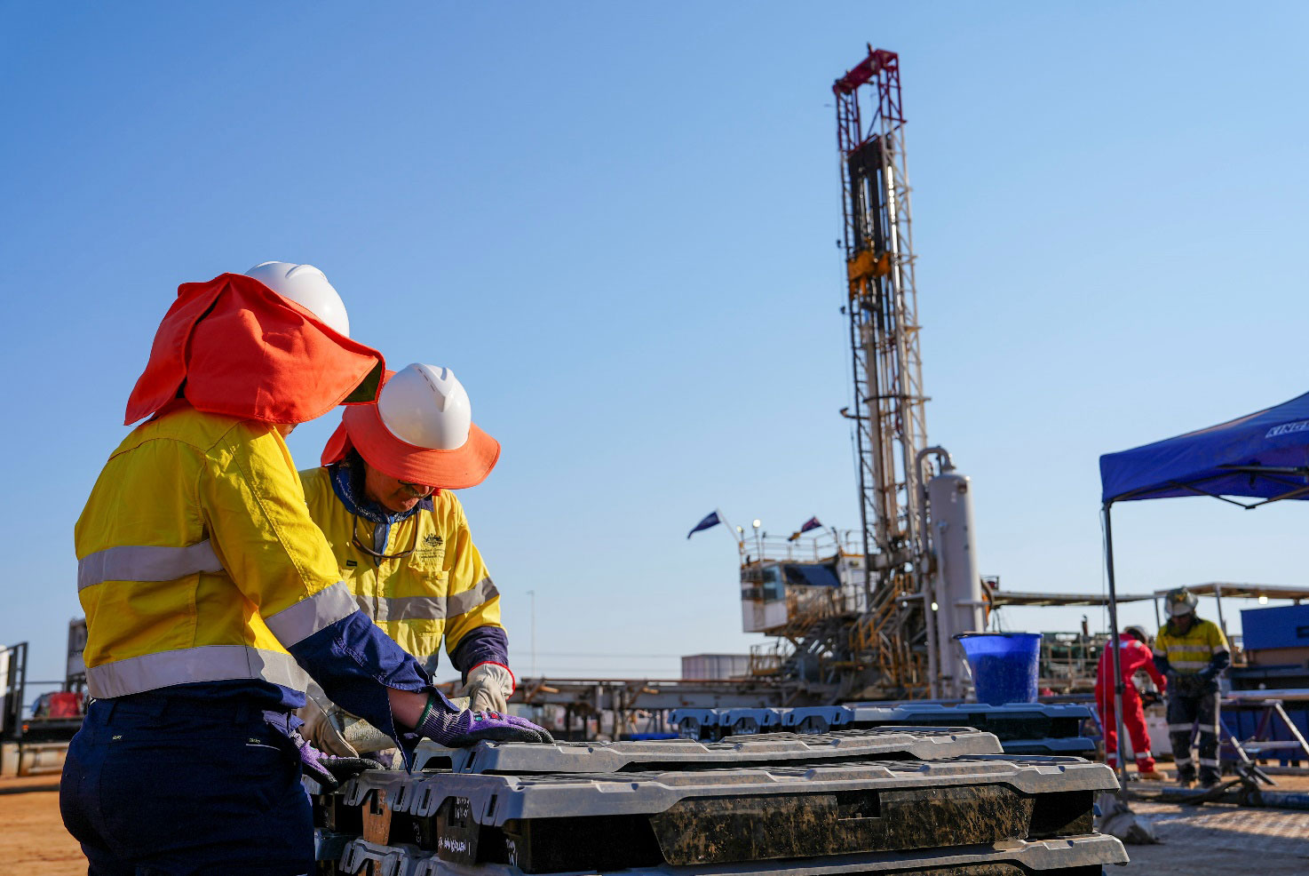 Geoscience Australia geologists inspecting core samples on site at the Adavale Basin drill location near Blackall.