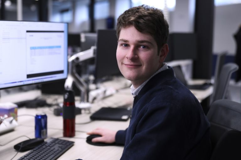 Geoscience Australia staff member working at a computer analysing geospatial and scientific data