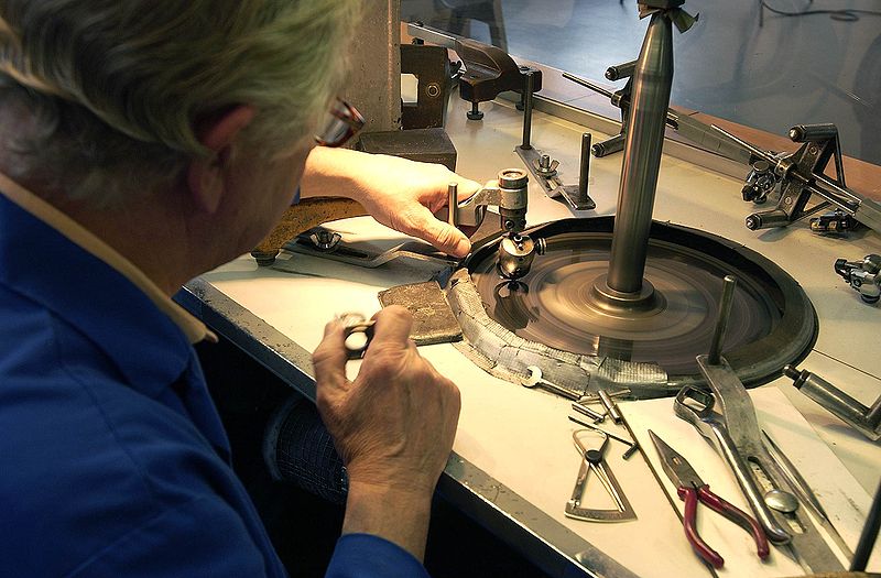 Man operating a diamond polishing wheel