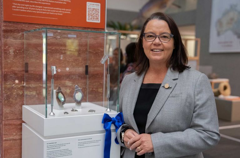 Madeline King standing next to the Yowah Moon opal at the Rocks that Shape Australia exhibition