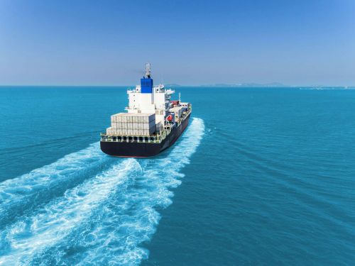 Cargo ship transporting shipping containers across open ocean, illustrating Australia's maritime trade routes and marine transport