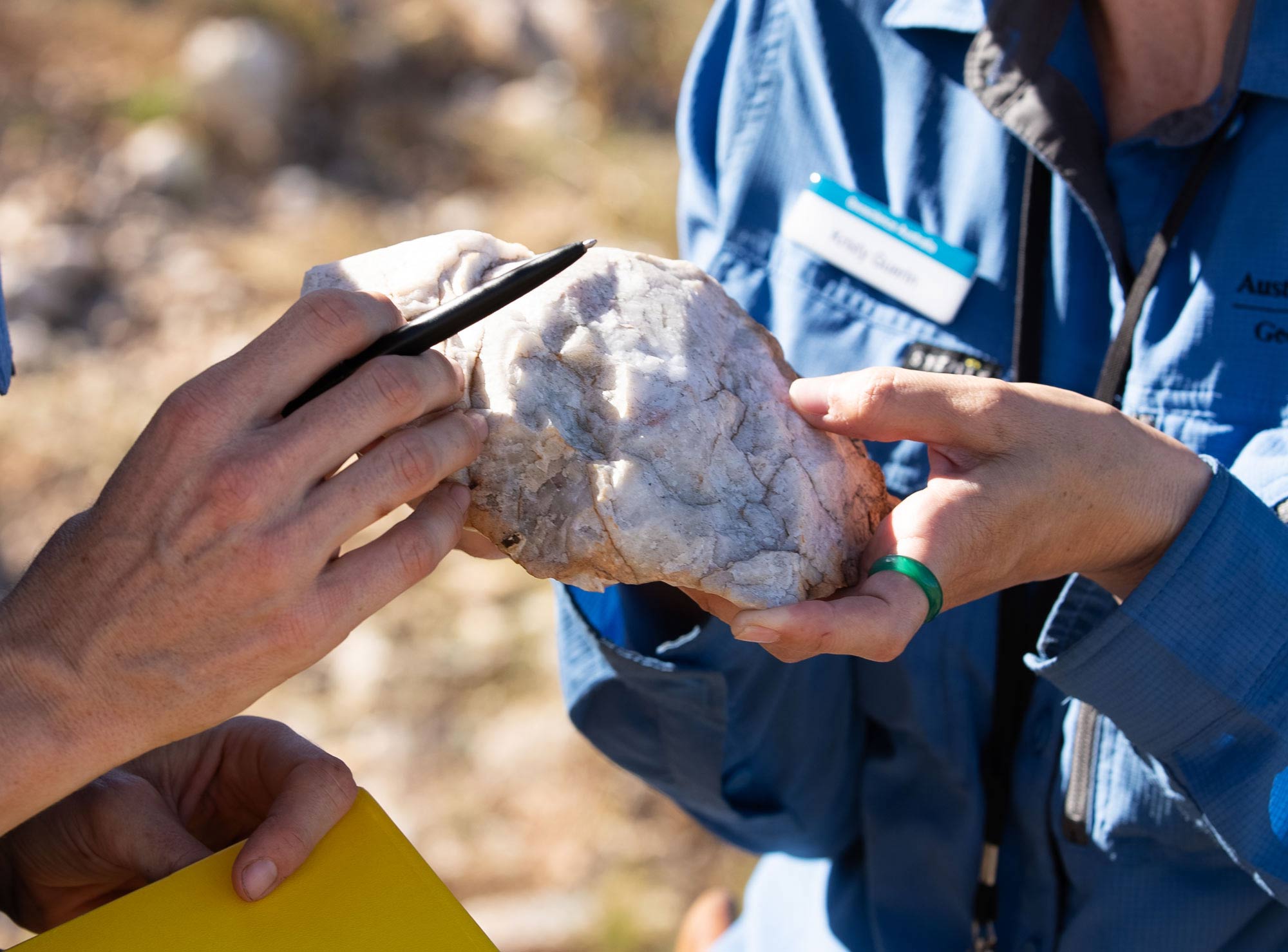 Close-up of geoscientists’ hands holding quartz in the Mount Isa Cloncurry Region.