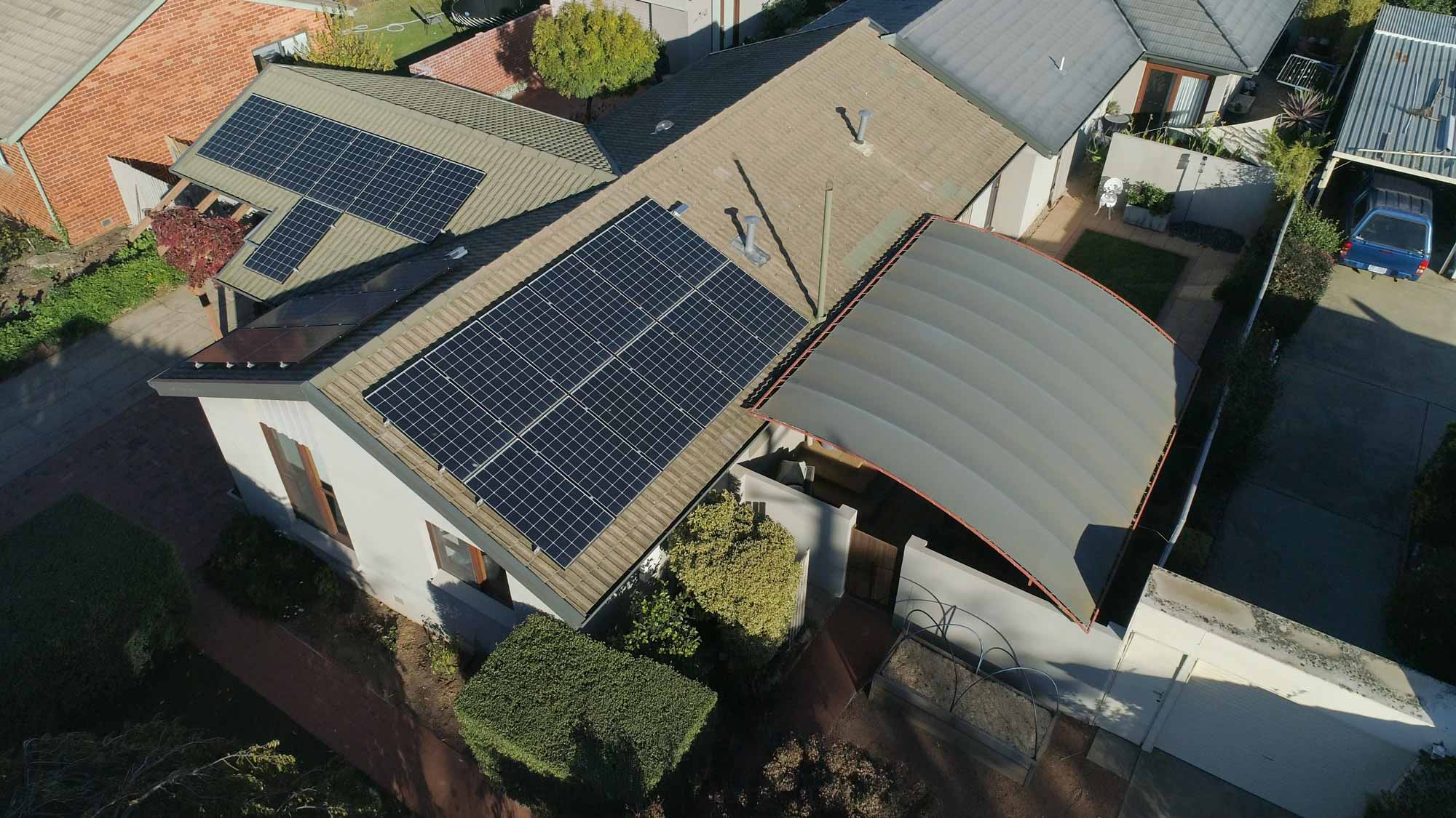 Aerial view of solar panels installed on the roof of a house.