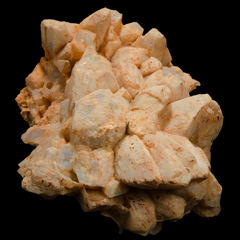 Mostly cream coloured, lobed mineral with a blue sheen in parts. The overall shape resembles a pineapple or pinecone