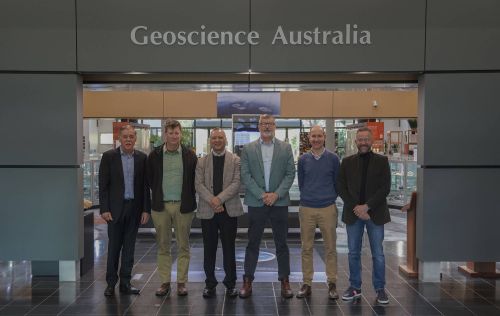 Left to right: Mark Edwards, Dylan Kendall, Professor Ora Renagi, John Dawson, Jonathan Bathgate, Hadi Ghasemi, photographed standing in the Geoscience Australia foyer.