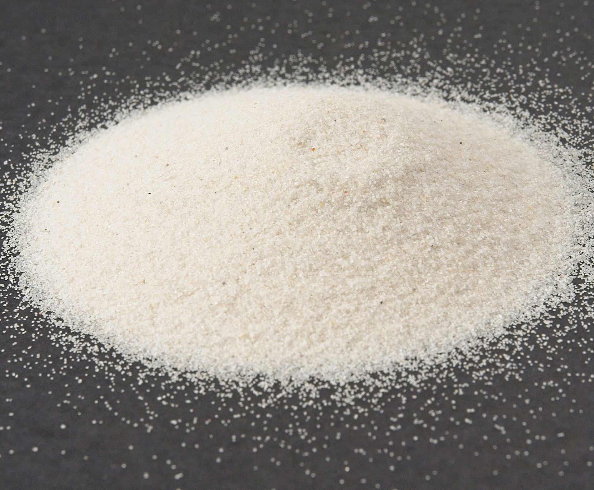Close-up of silica sand on a black background.