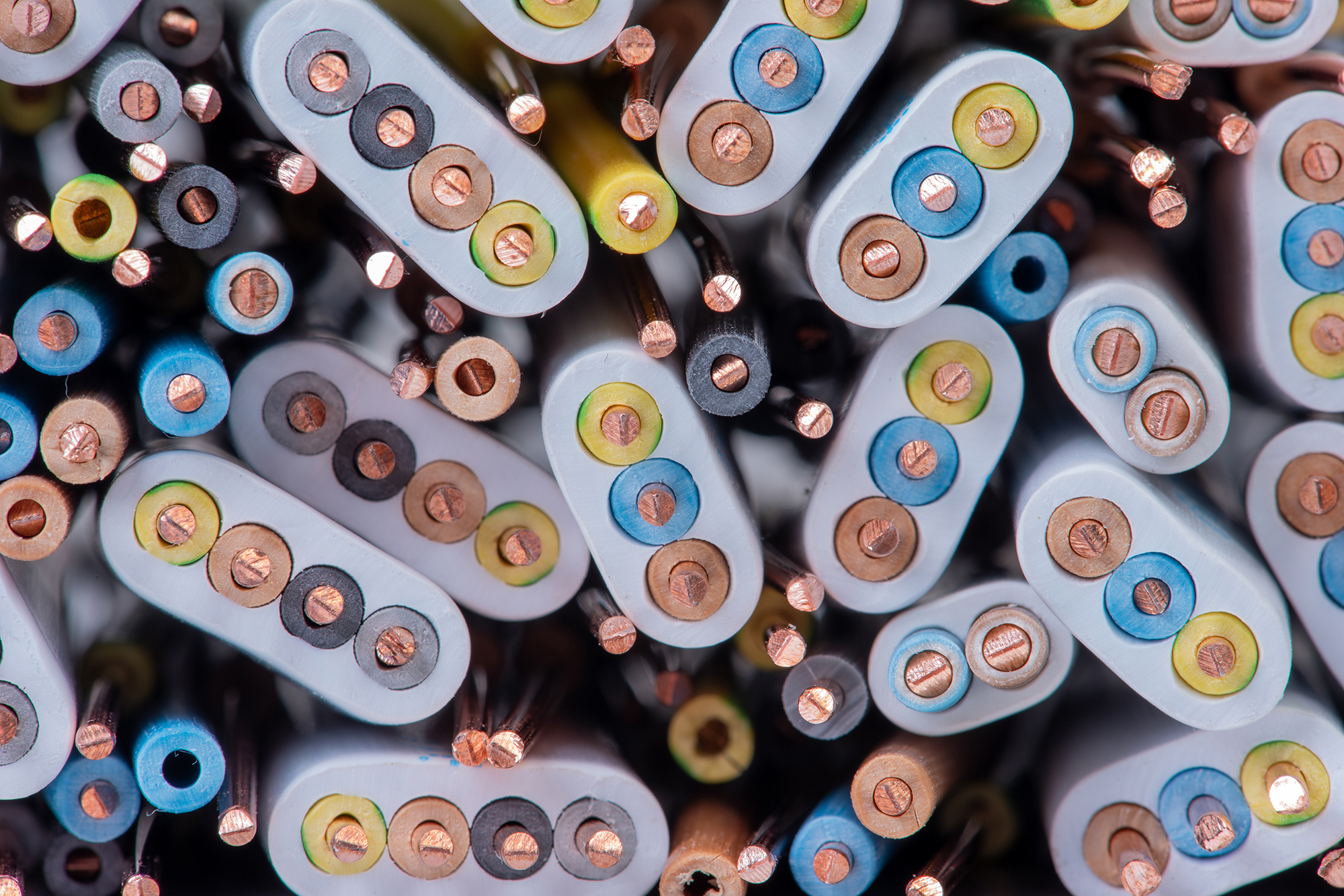 An assortment of copper cables and wires used in electronics and electricity production.