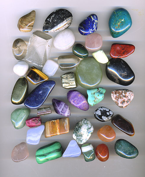 Rounded uncut, opaque and semi-transparent gemstones in a variety of colours