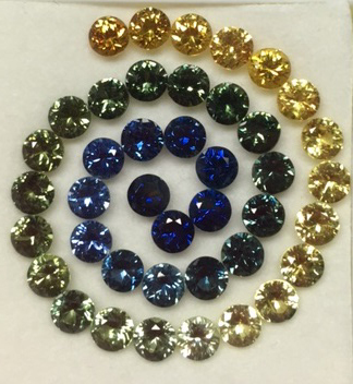 A spiral of yellow green and blue sapphire gemstones