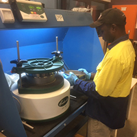 A trainee conducting soil sampling at the laboratory at the Centre for Appropriate Technology's facilities in Alice Springs. 