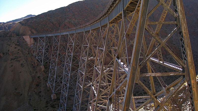 A curved bridge with steel lattice pylons