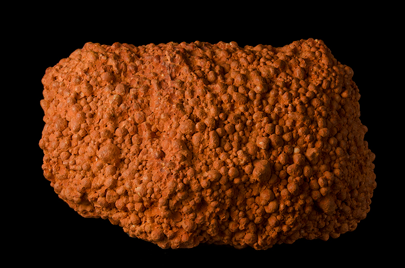 An orange coloured rock with rounded nodules