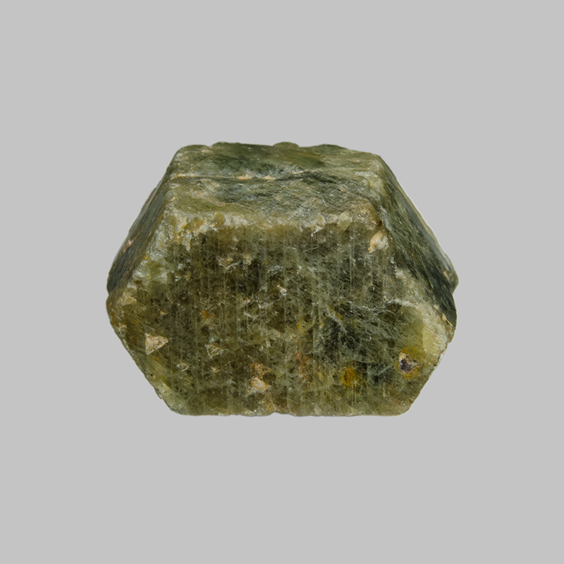 Hexagonal shaped green opaque corundum crystal