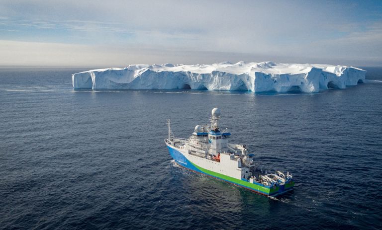 The Research Vessel Investigator in front of an iceberg on the Sabrina Coast margin in 2017.