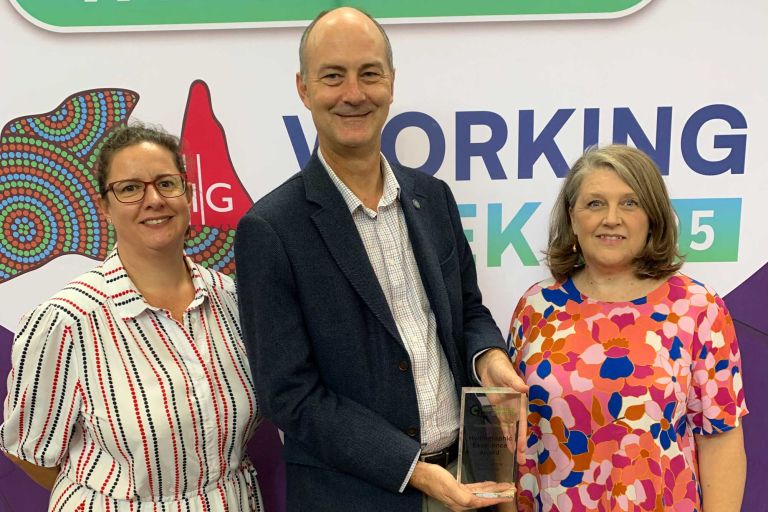 Geoscience Australia representatives accept an award for the AusSeabed Survey Coordination Tool at a professional conference