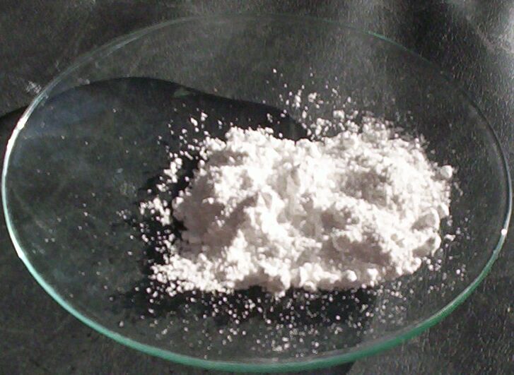 Pile of white titanium oxide powder on a glass dish