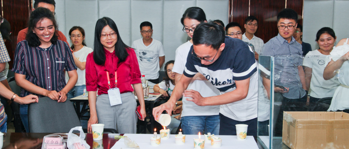 Carbon capture and storage workshop participants undertaking an experiment and extinguishing candles using a cup of carbon dioxide (CO<sub>2</sub>)