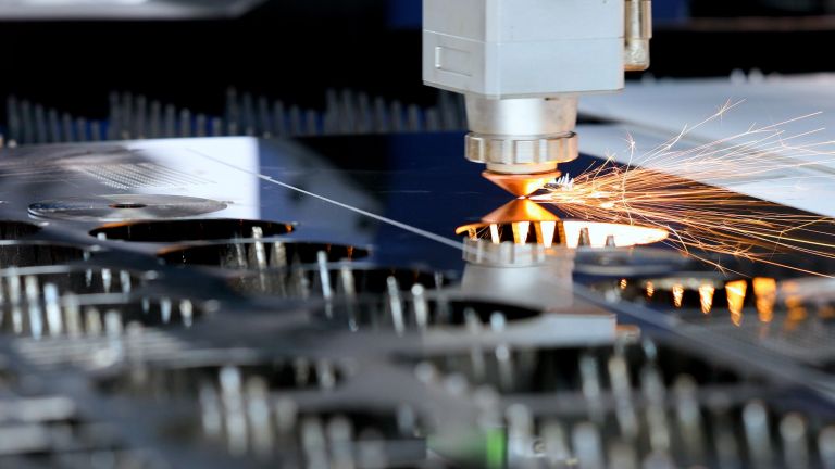 Close-up of an active industrial laser cutter