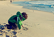 Child playing at the beach. Copyright Getty Images [A Lumsden].