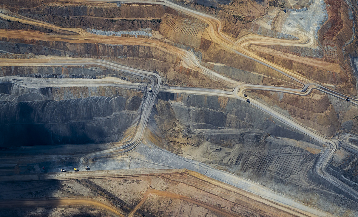 Birdseye view of Moranbah open-pit coal mine in central Queensland showing the mining levels and the different colours of the rock layers.