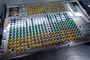 different types of titanium surgical screws are sorted into a tray according to size and type