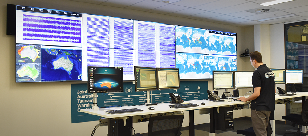 Staff member looking at computer screens in the Tsunami Warning Centre
