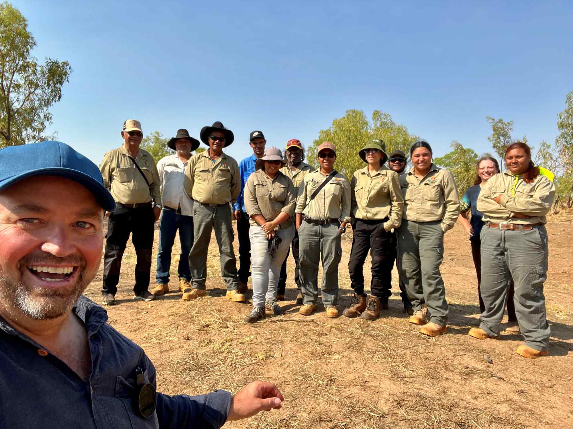 A group of people taking a photo outside