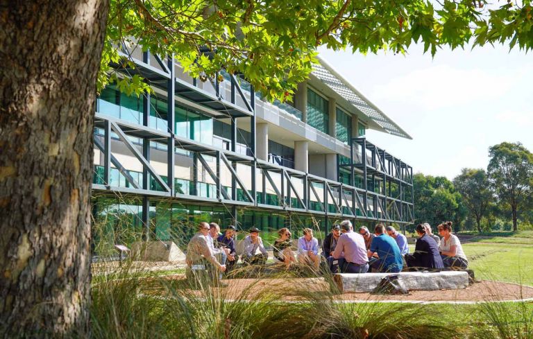 Geoscience Australia staff and visitors gather outside for a meeting