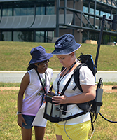 Two high-school students use scientific equipment to take geomagnetic measurements