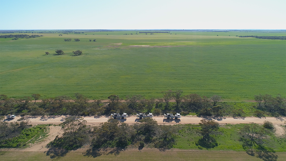 A convoy of vibroseis trucks as seen from a Drone