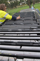A scientist labelling trays of drill core samples