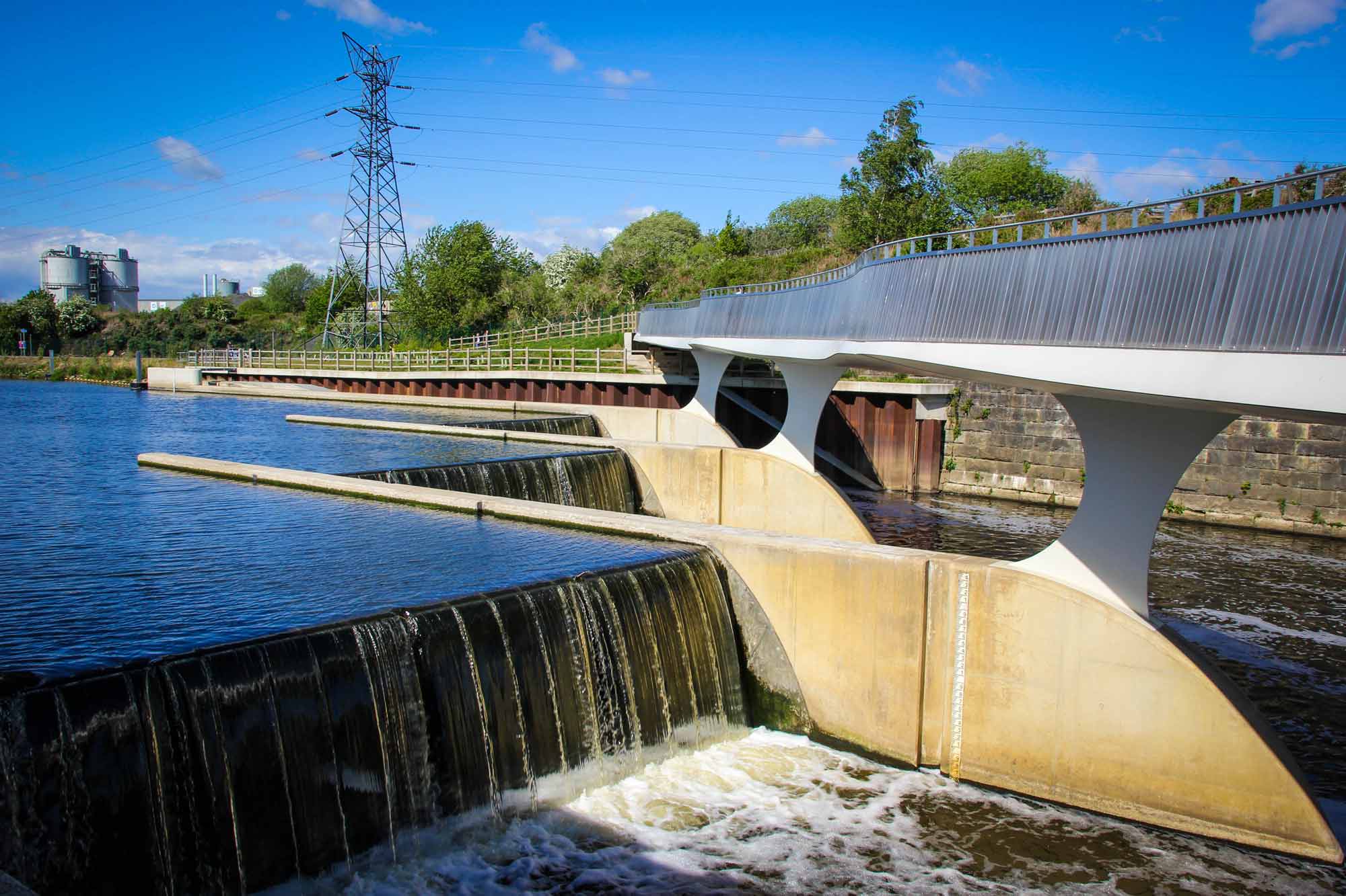 water running under a bridge, with the flow controlled by the built environment