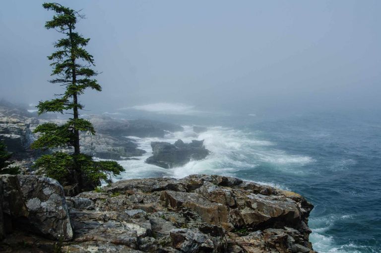 Standing on a cliff face looking out to sea during a wild storm