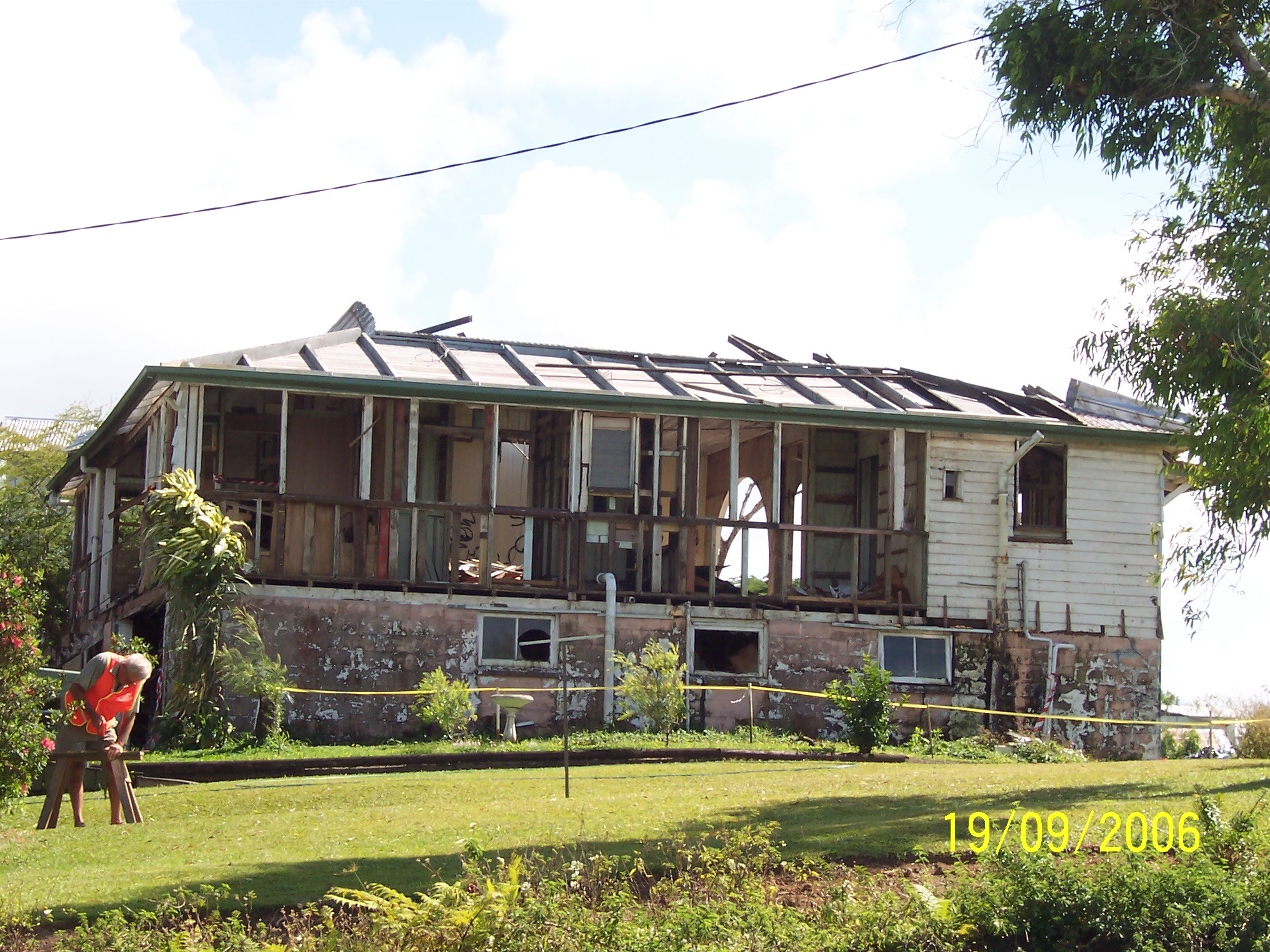 A resident rebuilding their damaged home after Tropical Cyclone Larry